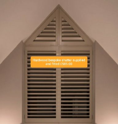 Closed wooden shutters with a triangular top.